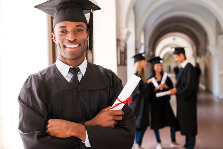 college graduate holding his diploma | Sutherlin Subaru in Kingston TN