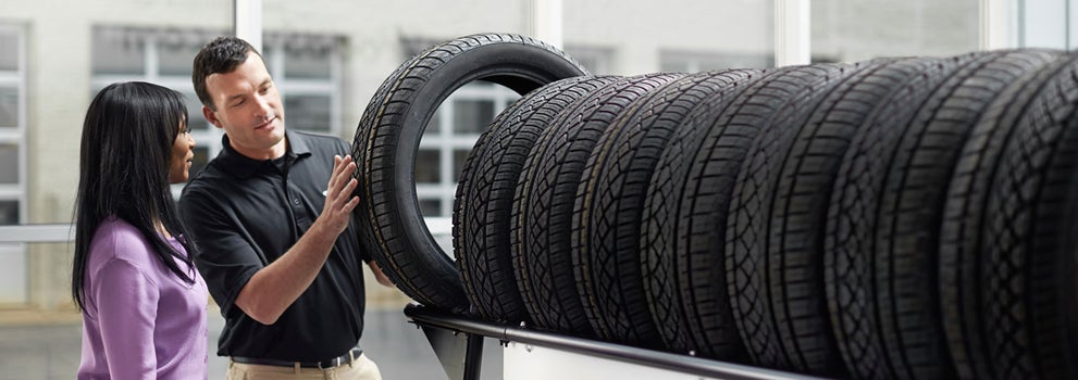 Subaru service representative showing customer a tire. | Sutherlin Subaru in Kingston TN